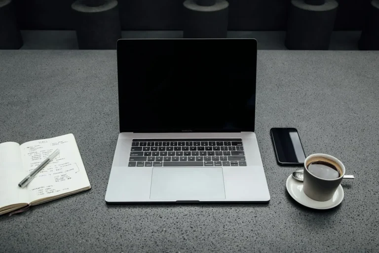 Laptop, notebook and coffee on a desk