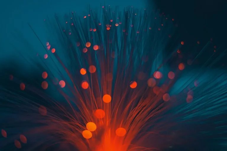 Fibre-optic strands glowing orange and teal